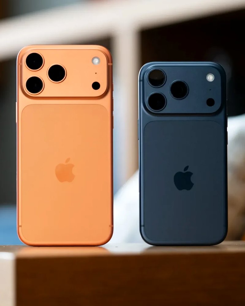 Dos iPhone Pro de última generación, uno naranja y otro azul, vistos por detrás
